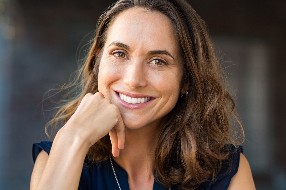 Periodontist reviewing 3D dental scans with a full-arch implant patient