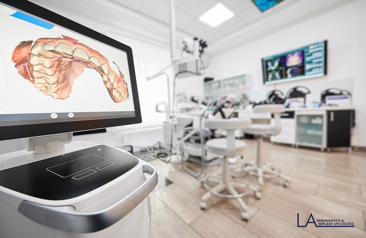 Periodontist reviewing a 3D CBCT scan on a monitor at LA Periodontics