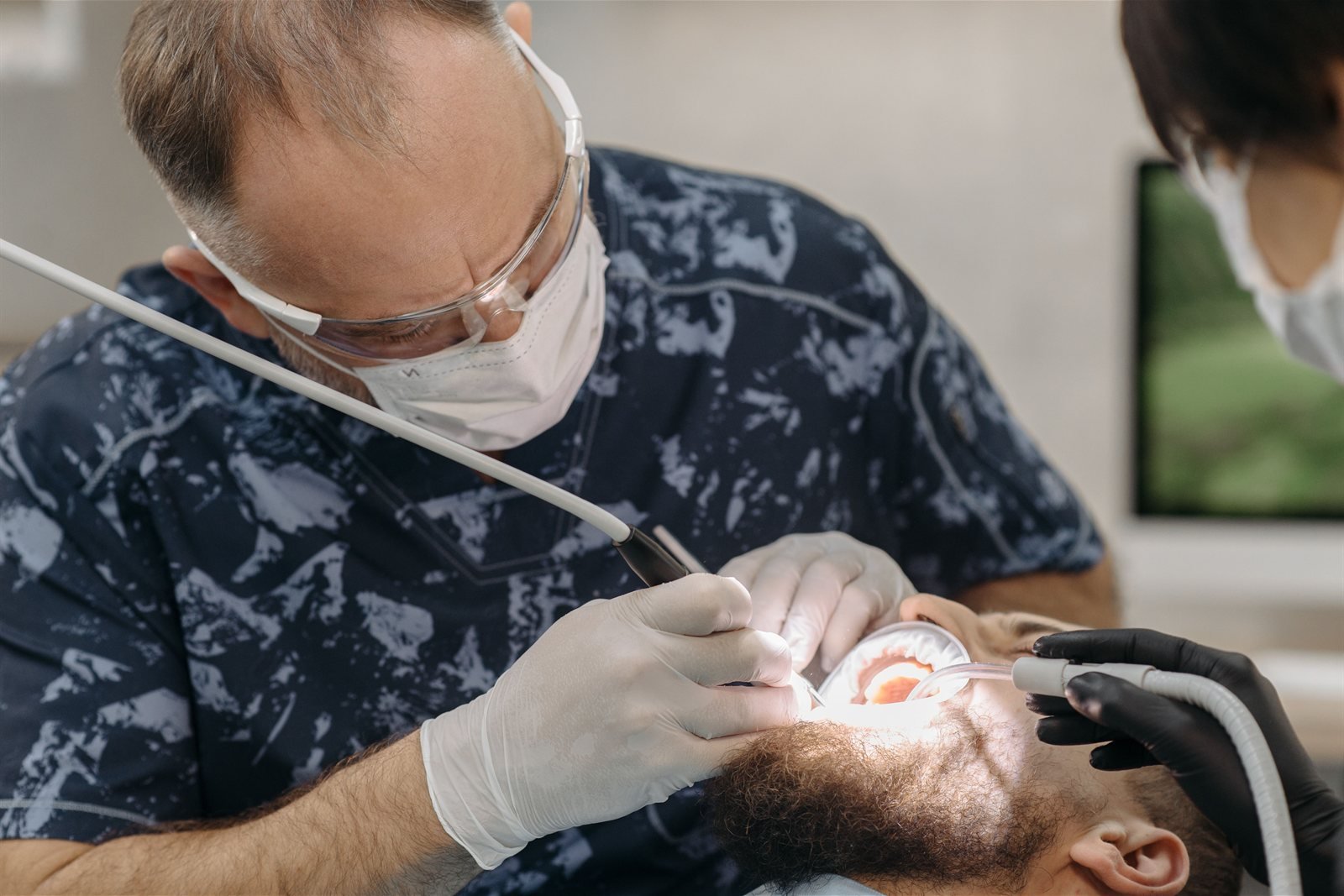 Periodontist examining a patient's gums before a gum graft procedure in Los Angeles