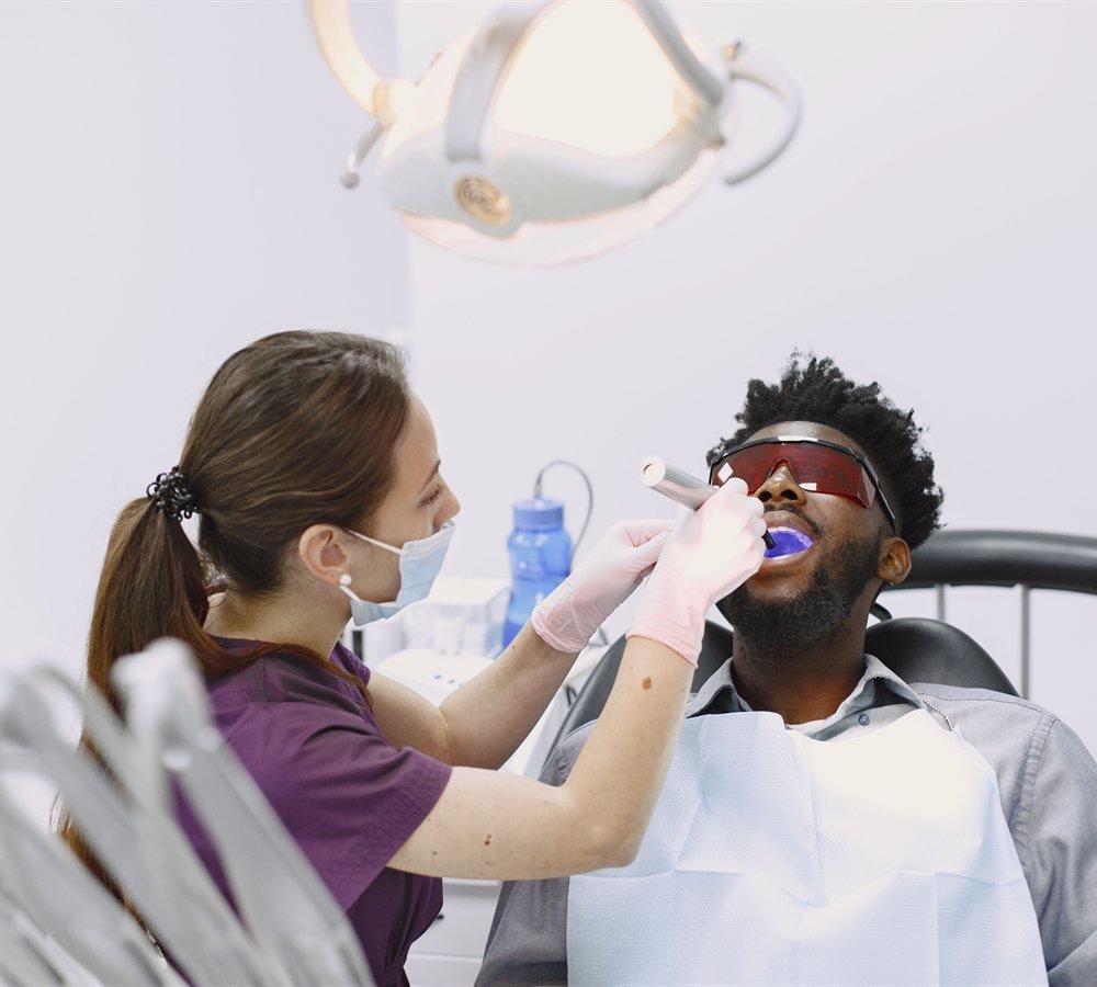 Dentist fitting a custom occlusal guard for a patient with bruxism